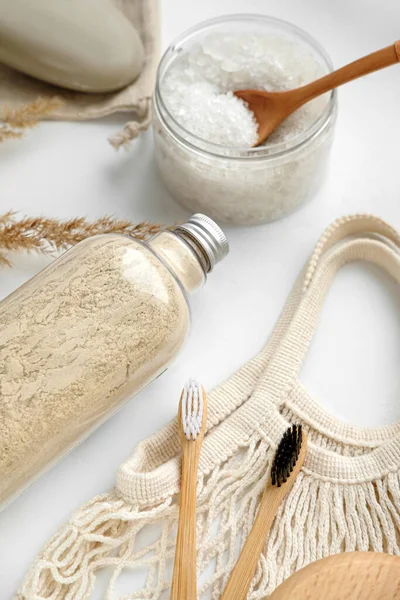 Body scrub, soap, string eco bag, beech toothbrushes, sea bath salt,body brush and other spa objects on light background — ストック写真