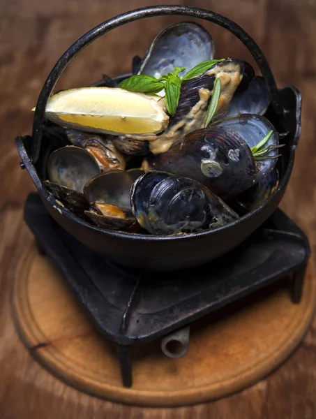 limon ve fesleğen bir ahşap tahta üzerinde midye