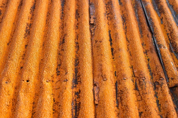 Layer of rusty roof metal sheet. Rusty texture