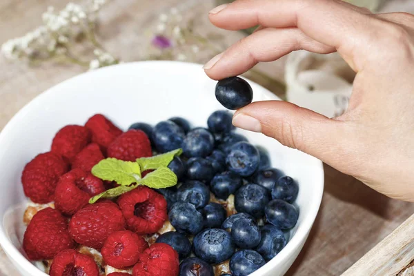 Oatmeal with blue berries and raspberries