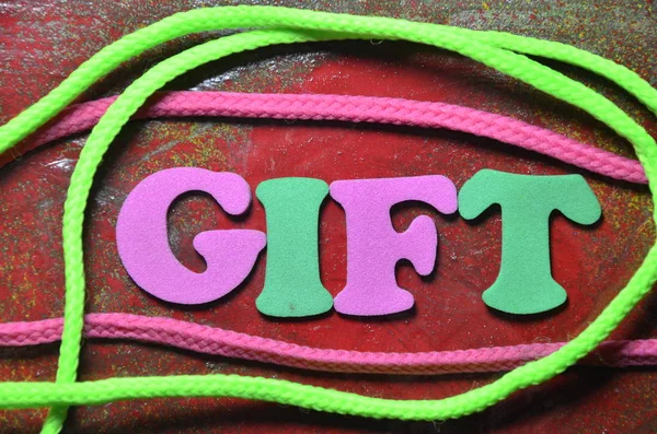 Woord Gift Een Abstract Gekleurde Achtergrond — Stockfoto