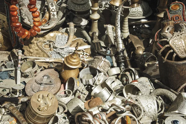 Essaouria, Morocco - September 2017: trinket stall selling tea pots, Jewelry and all kinds of metal objects in the market plac