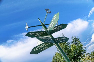 Nuwara Ellya, Sri Lanka: Sri Lankan sign post pointing to various locations - tilted