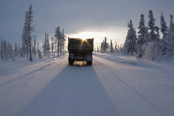 Far North. The truck is moving along the winter road.