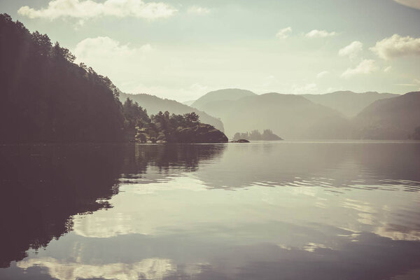 Landscape with a water surface and fog. A good start to the day on the Scandinavian lake, an easy fog.