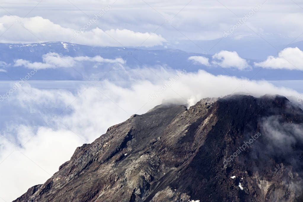 Alaskan peak surrounded by smoky clouds