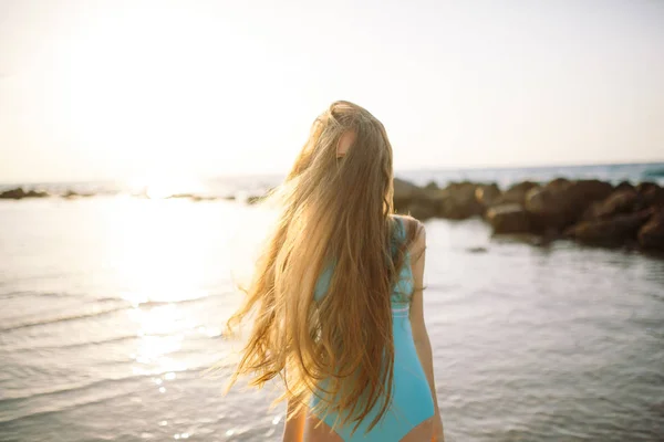 Girl with beautiful hair covering face on beach at summer. — Stock Photo, Image