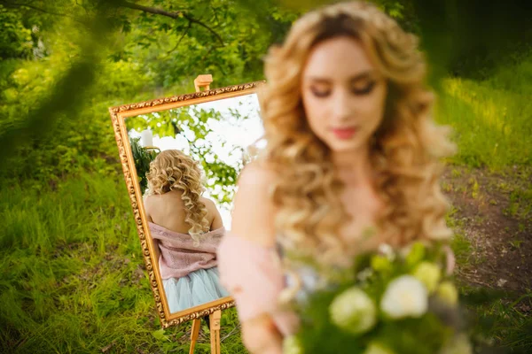 Stylish blonde bride in mirror, view from back in mirror — Stock Photo, Image