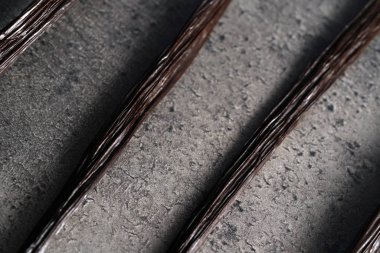 Bourbon vanilla sticks on stone like board, close up photo from above clipart
