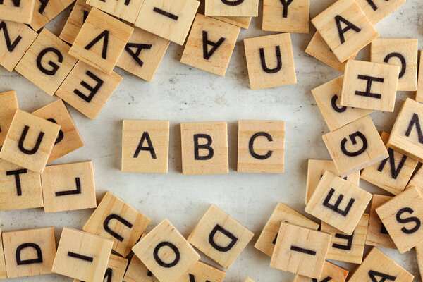 Top down view, pile of square wooden blocks with letters ABC on 