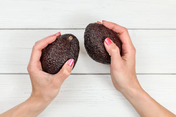 Top down view, woman hands with pink nails holding two whole dar — Stock Photo, Image