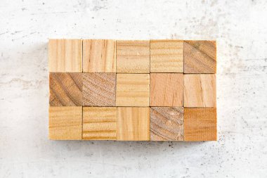 Düz yatıyordu, 15 tahta küp 3 x 5 ızgarada düzenlenmişti. 