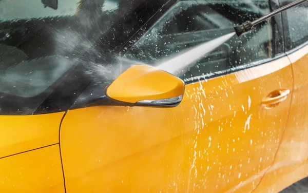 Side mirror of car washed in self serve carwash, jet water spray — Stock Photo, Image