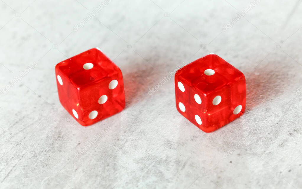 Two translucent red craps dices on white board showing Snake Eyes (Double number 1)