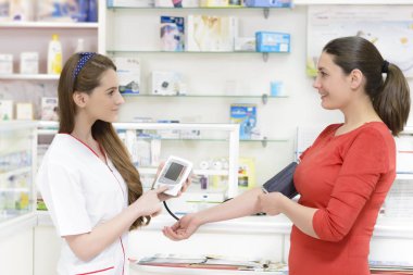 Bir tonometer gösterilen eczacı