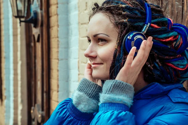 Girl in blue headphones — Stock Photo, Image
