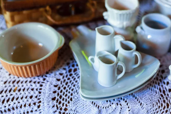 Pitcher milk coffee on dish.