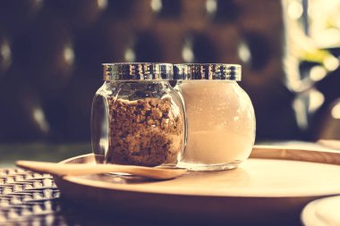 Bir fincan kahvenin yanında, tencerede şeker..