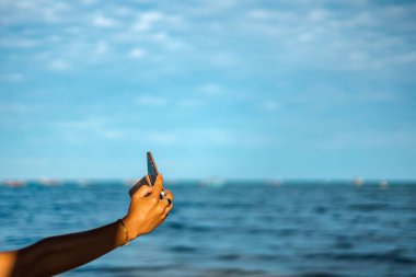 Kumsalda el ele tutuşan cep telefonu..