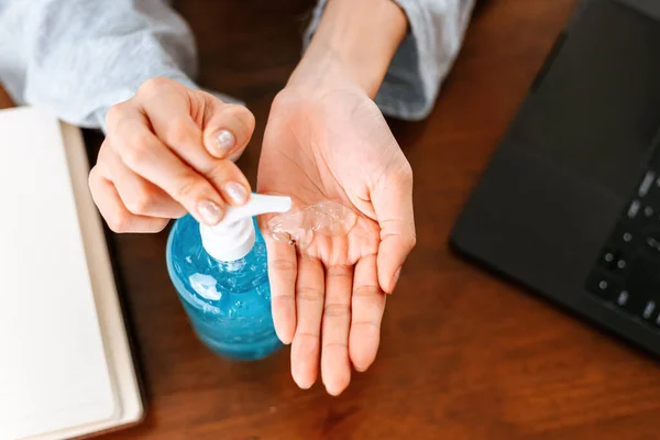 Working from home. Cleaning hands with sanitizer gel. Business