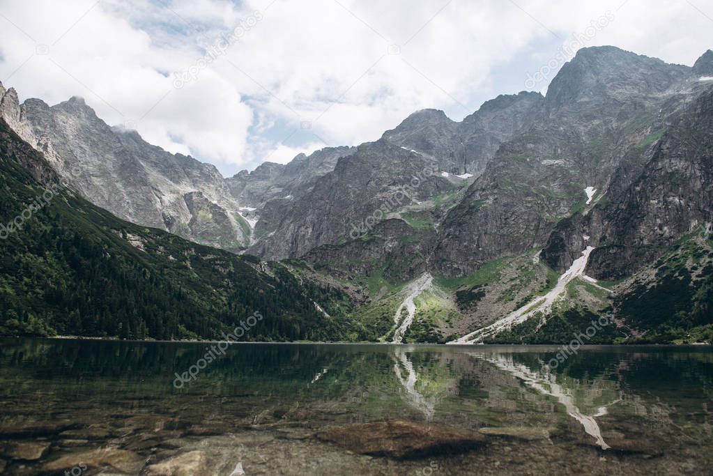Reflected beautiful mountain lake with mountain range at background