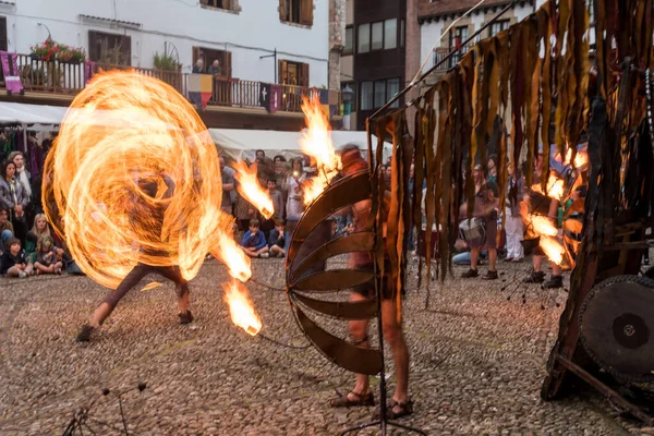 Playing with fire making circles at the medieval fair