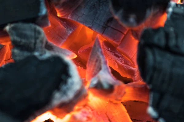 Charcoal embers burning with fire and ashes preparing for a spring and summer barbecue
