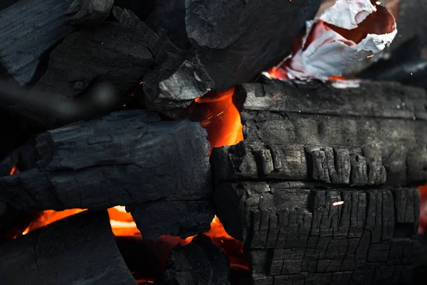 Charcoal embers burning with fire and ashes preparing for a spring and summer barbecue