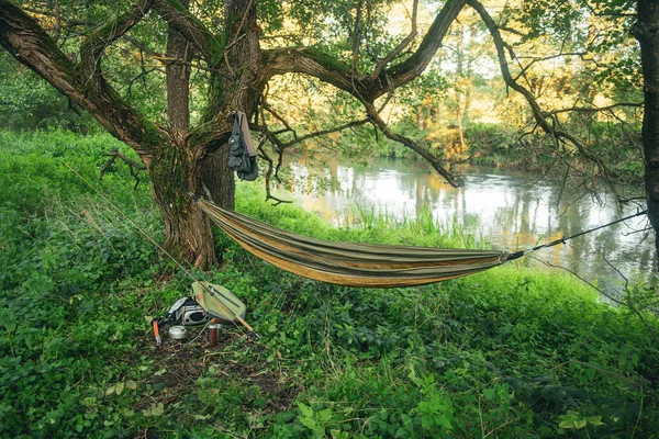 Hammock and fishing equipment on the river. — 스톡 사진