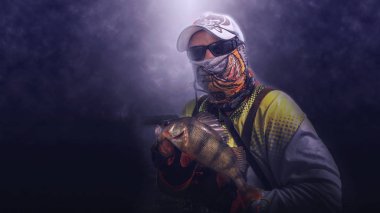 The angler with perch. Fishing with spinning.