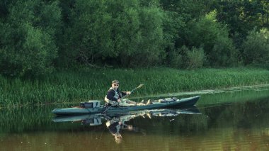 Fishing on the kayak. Spinning fishing.