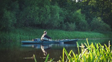 Fishing on the kayak. Spinning fishing.