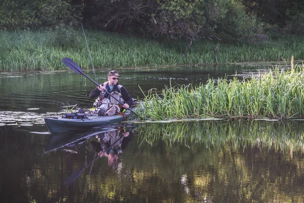 Fishing on the kayak. Spinning fishing.