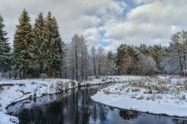Winter snow-covered river. The nature of Belarus.
