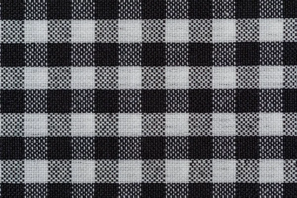 Checkered fabric background. Black cell. Top view, flat lay