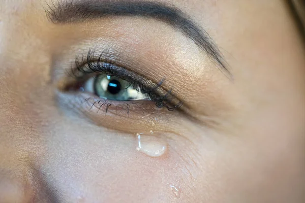 Eye of a girl with a tear — Stock Photo, Image