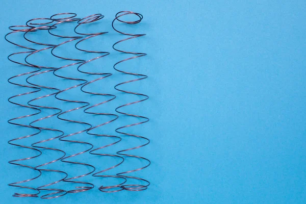 Independent mattress springs on the table. Top view with copy space, flat lay.