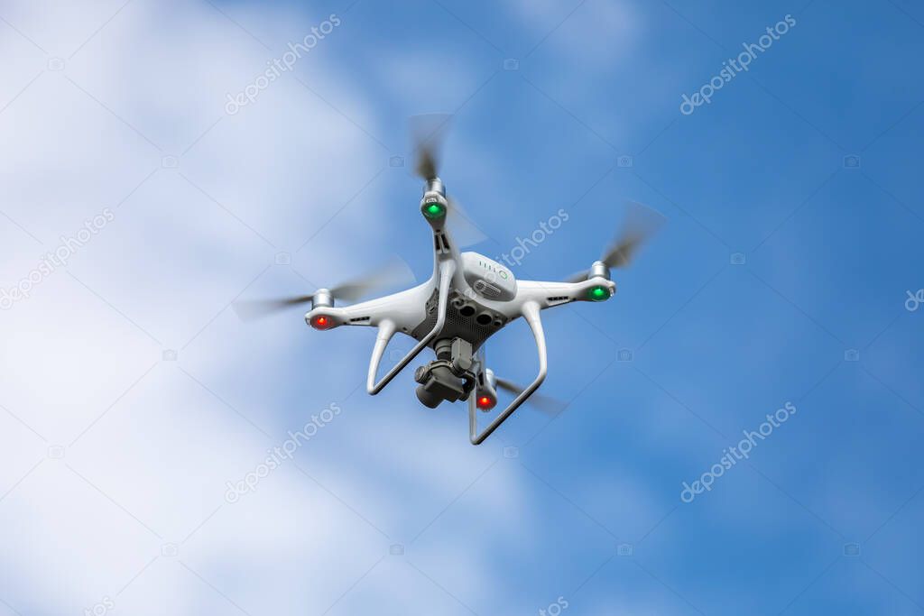 Drone quadrocopter with high resolution digital camera on the sky background.