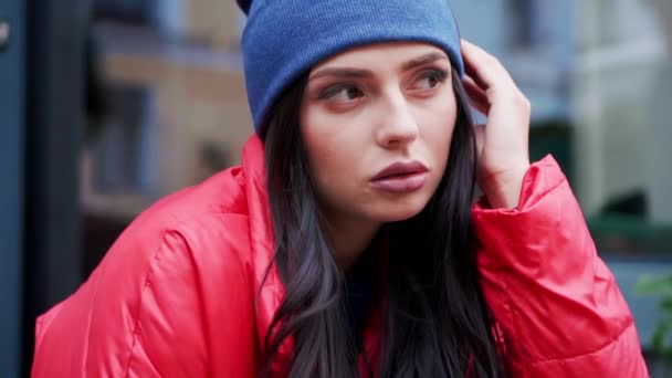 Fashion style portrait of young trendy girl sitting on a stairs — Stock Video