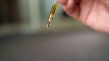 Pipette 'ten damlayan su. Yakın çekim video. Tıbbi ve kimya laboratuvarı araştırması