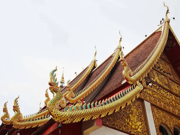 Beautiful Temple Roofing Decorated with the Golden King Naga Serpent Sculptures