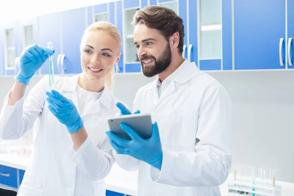 Biólogos alegres y positivos de pie en el laboratorio — Foto de Stock