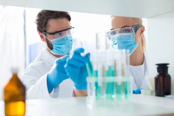 Nice smart biologists working in the lab — Stock Photo, Image