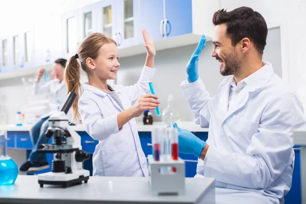 Joyful merry man and girl receiving result — Stock Photo, Image