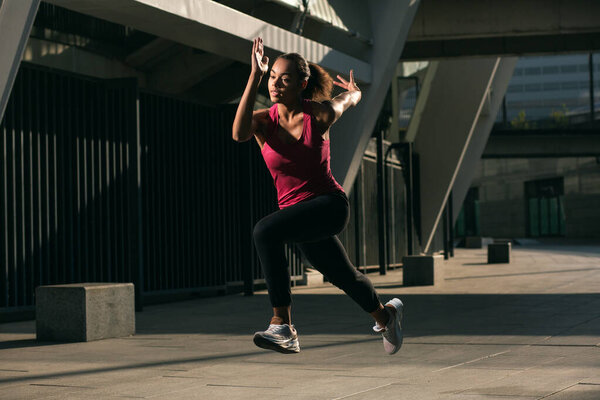 Serious professional athlete running outdoors alone at daytime