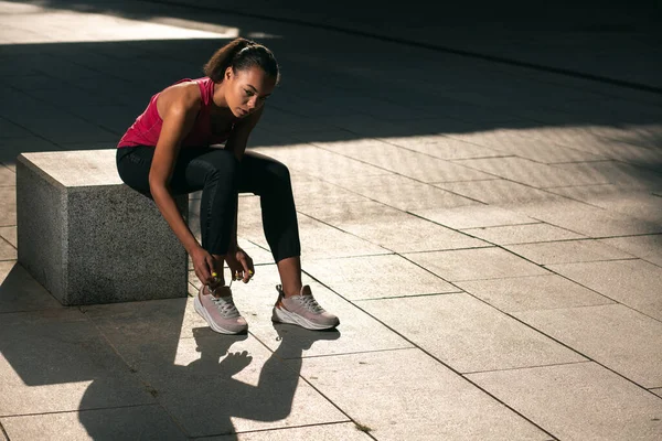 Joven Atleta Tranquila Sentada Cubo Piedra Aire Libre Atando Sus — Foto de Stock