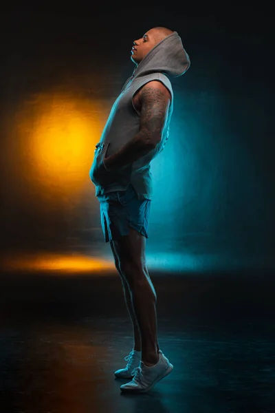 Young Man Shorts Vest Standing Tips His Toes Colorful Light — Stock Photo, Image