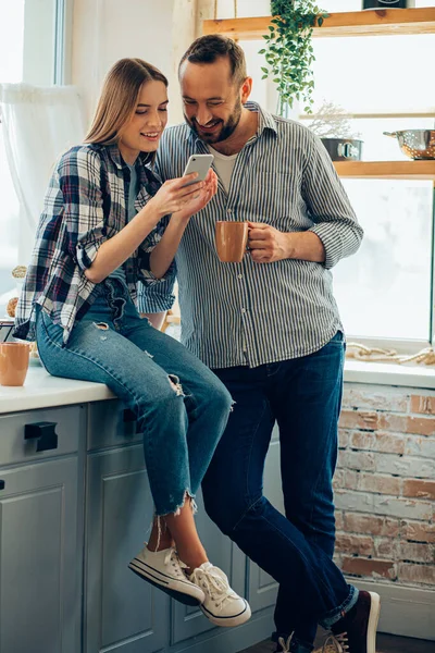Homem Mulher Alegres Cozinha Sorrindo Olhando Para Smartphone — Fotografia de Stock