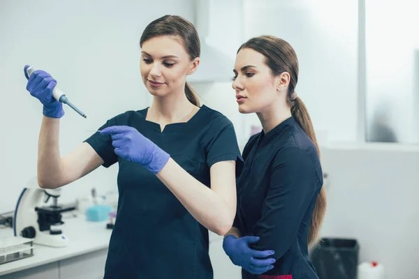 Две Молодые Женщины Медицинской Форме Стоят Лаборатории Работают Образцами — стоковое фото