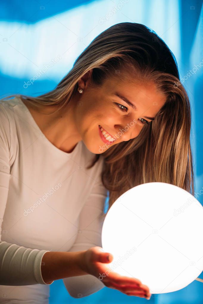 smiling beautiful woman looking a crystal ball